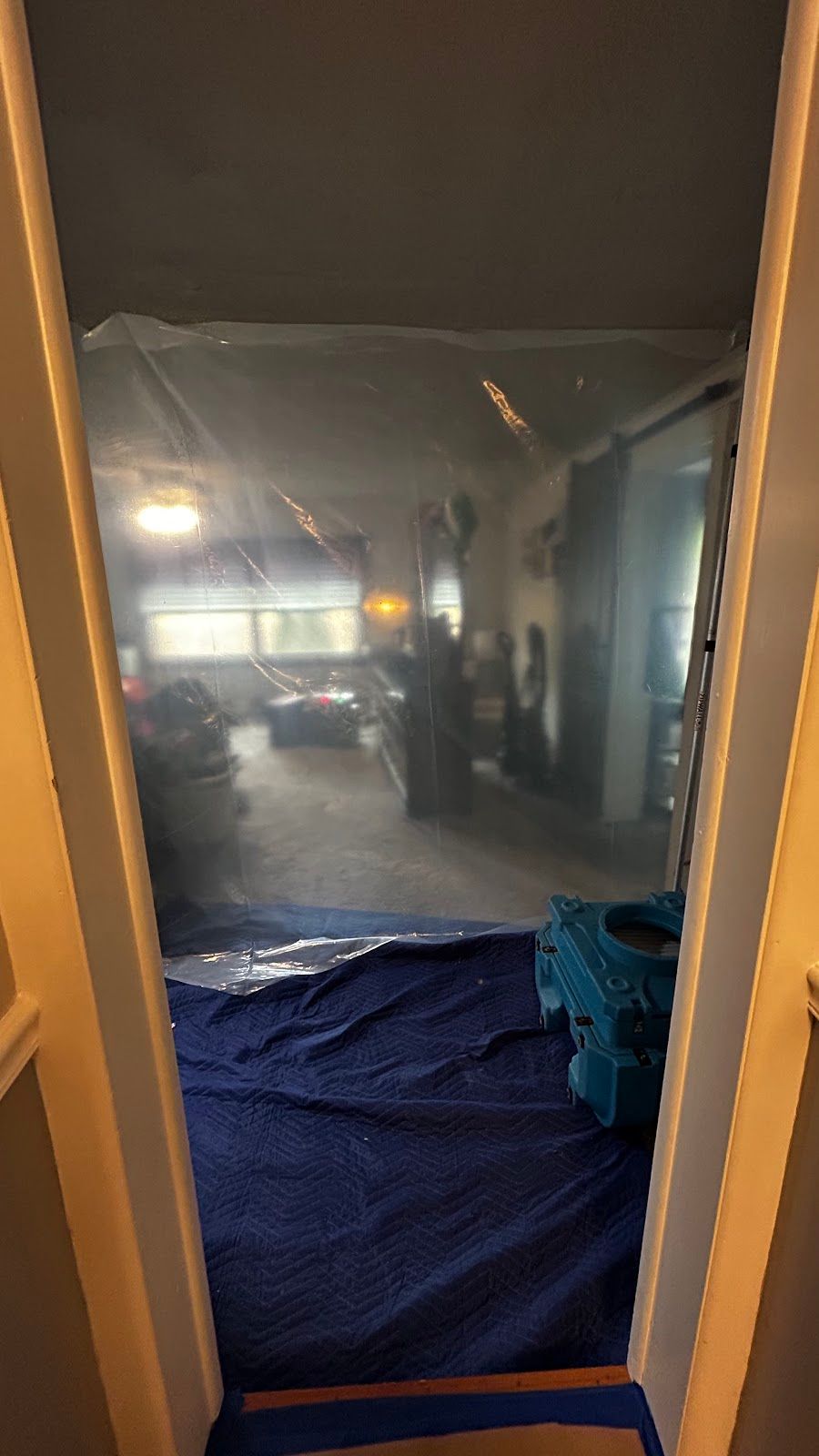 Plastic containment barrier enclosing a restoration work area